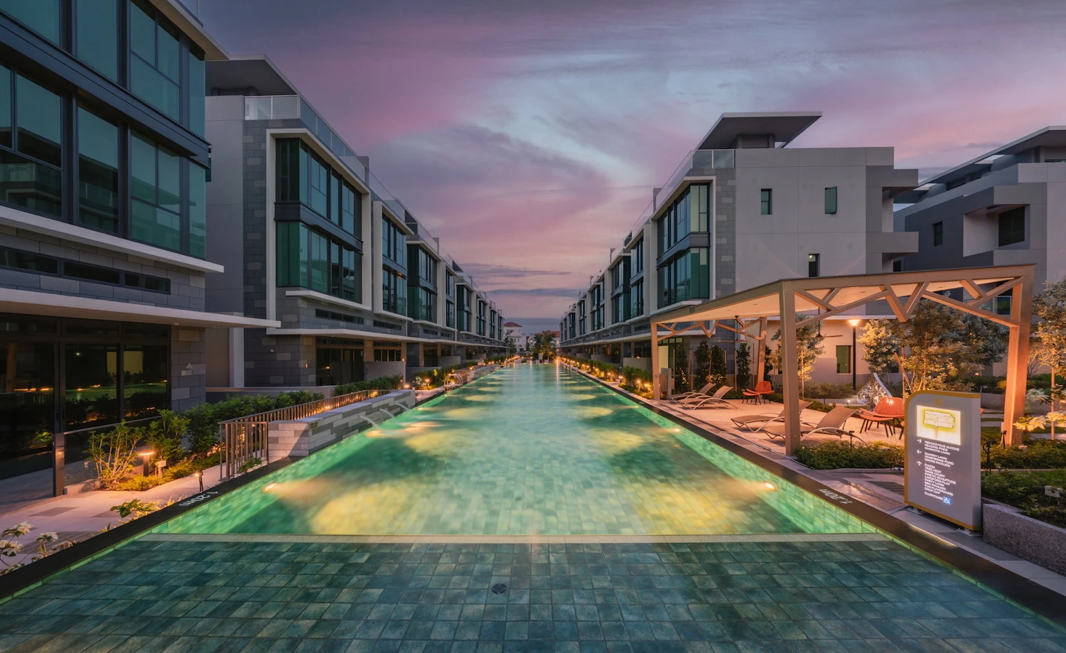 Belgravia Ace swimming pool illuminated at dusk